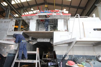 Boat builders welding the hull